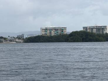 A view of buildings along the waterfront, with unclear visibility of the surroundings. The image lacks focus on any specific subject.