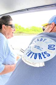 Two individuals enjoy a moment on a boat, showcasing the adventure spirit of a tour. Perfect for those seeking memorable experiences on the water.