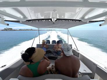 A group enjoys a relaxing ride on a boat, surrounded by beautiful waters — perfect for a day of adventure and fun on the sea.
