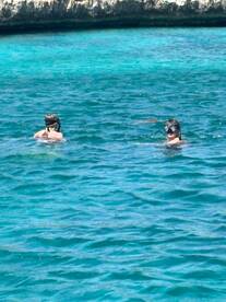 Two snorkelers explore the vibrant underwater world in crystal-clear waters, perfect for aquatic adventures and marine life encounters.