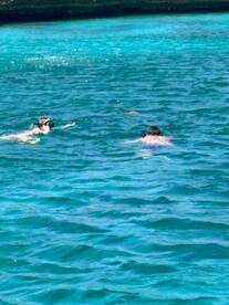 Two snorkelers explore the vibrant underwater world in crystal-clear waters, perfect for an adventurous day of snorkeling.