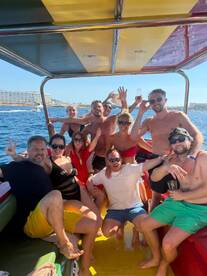 A lively group of friends enjoys a fun day on the water, celebrating together on a boat — perfect for summer adventures and unforgettable memories.