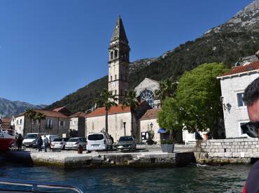 A picturesque view of a charming harbor with historical architecture and a clock tower, showcasing the vibrant atmosphere of coastal life.