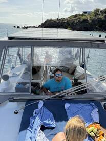 Guests enjoy a relaxing moment aboard a boat, with snacks laid out and scenic views in the background — perfect for a leisurely day on the water.