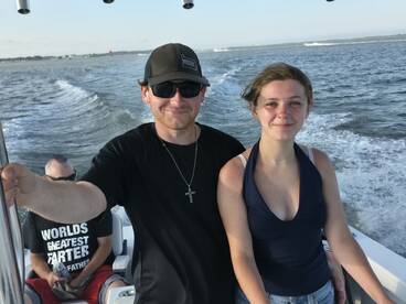 A young woman and a man enjoy a fun day on the water, showcasing the joy of boating with friends. Perfect for capturing memorable moments on the sea.