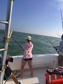 A group of friends enjoys a fishing trip on the open water, casting their lines and embracing the thrill of the catch.