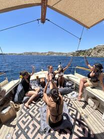 A lively group of friends enjoys a fun celebration aboard a boat, soaking up the sun and making memories on the water.