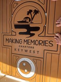 The deck of a charter boat featuring the logo 'Making Memories Charters' in Key West, showcasing a welcoming atmosphere for guests.