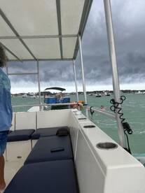 A lively scene aboard a boat with guests enjoying the water, showcasing the fun and excitement of a day on the water.