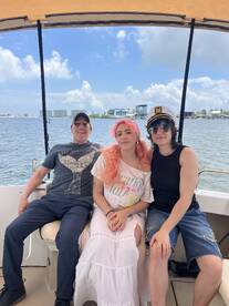 A cheerful group enjoys their time aboard a boat, capturing a moment of fun and relaxation on the water.