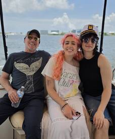 A cheerful group of friends enjoys their time on a boat, capturing the essence of fun and camaraderie on the water.
