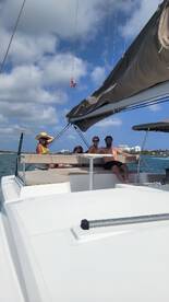 A family enjoys a relaxing day sailing on a catamaran, capturing the joy of togetherness on the water.