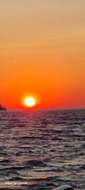 A stunning sunset over the ocean, creating a picturesque backdrop for evening boat cruises.
