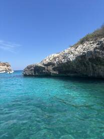A stunning view of a rocky coastline with crystal-clear turquoise waters, perfect for exploring hidden coves and enjoying the beauty of nature.