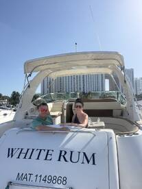 A couple enjoys a sunny day aboard the 'White Rum' yacht, perfect for romantic outings or celebrations on the water.