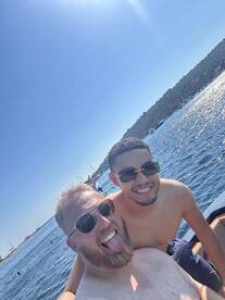 Two friends enjoy a sunny day on the water, capturing a fun moment while swimming and celebrating together — perfect for summer adventures.