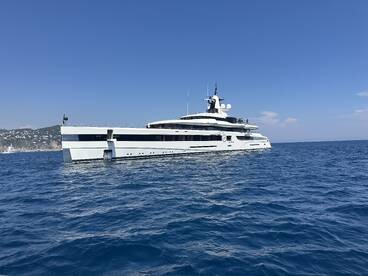 A stunning yacht glides through the clear blue waters, showcasing its sleek design and elegance — perfect for luxury charters and coastal adventures.