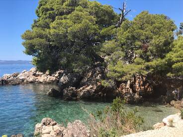 A picturesque view of a rocky coastline with clear turquoise waters, perfect for exploring hidden gems and enjoying nature's beauty.