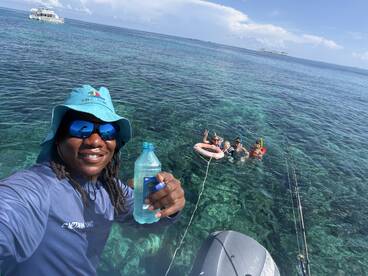 A joyful group enjoys snorkeling in crystal-clear waters, with a friendly guide capturing the moment. Perfect for family adventures and aquatic explorations.