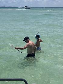 A father and son enjoy a fun day of snorkeling in clear waters, showcasing a perfect family adventure at the beach.