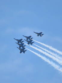 A formation of jets flying in the sky, showcasing aerial maneuvers. Perfect for aviation enthusiasts and airshow events.