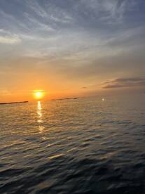 A stunning sunset over calm waters, capturing the serene beauty of a boating experience. Perfect for sunset cruises and tranquil evenings on the water.