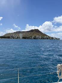 A stunning view of Diamond Head and the coastline of Honolulu from the water, showcasing the beauty of Hawaii's landscape.