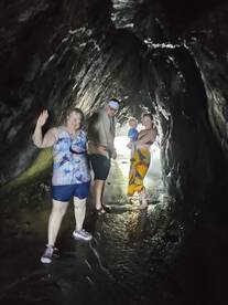 A family explores a stunning cave, creating unforgettable memories during their adventure — perfect for those seeking unique experiences on their trips.