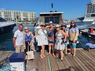 A cheerful group poses together at the dock, ready for a day of adventure on the water. Perfect for showcasing memorable moments with friends and family.