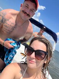 A cheerful group of friends enjoys a sunny day on the boat, capturing fun moments together — perfect for summer adventures on the water.