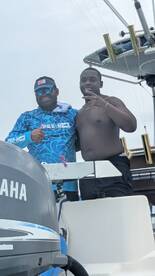 Two friends pose together on a boat, showcasing a fun moment on the water. Perfect for capturing memories during a boating adventure.