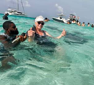 A joyful interaction with stingrays in crystal-clear waters, showcasing a memorable wildlife experience in a tropical paradise.