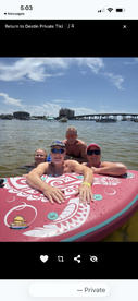 A joyful family enjoys a fun day on the water, lounging on a floating mat under the sun — perfect for summer adventures in Destin.