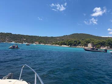 A vibrant scene of jet skiers enjoying the clear turquoise waters, with a picturesque coastline in the background — perfect for water sports and summer adventures.