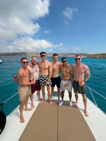 A group of friends enjoys a fun day on the water, celebrating together on a boat — perfect for summer outings and memorable adventures.