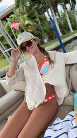 A woman enjoys a sunny day on a boat, showcasing a vibrant bikini and relaxed vibe — perfect for summer outings and water adventures.