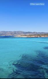 A stunning view of the Blue Lagoon in Paros, showcasing crystal-clear waters and a picturesque coastline — an ideal destination for boat trips and relaxation.