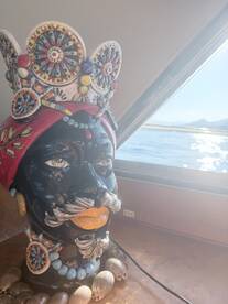A decorative sculpture adds a unique touch to the interior of the boat, showcasing artistic flair against a backdrop of serene waters.