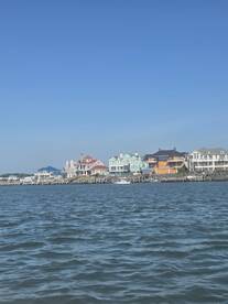 A view of waterfront homes against a clear blue sky, showcasing the scenic coastal architecture.