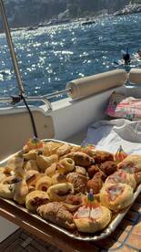 A beautifully arranged platter of snacks on a boat, perfect for enjoying while cruising on the water. Ideal for catering during a day out at sea.