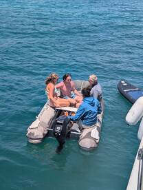A lively group enjoys their time on a small boat, creating memorable moments on the water. Perfect for a day of adventure and fun in the sun.