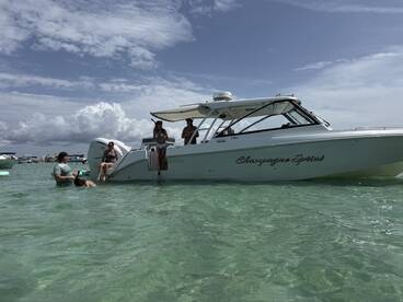 A lively group enjoys a day on the water with the 'Champagne Sprint' boat, swimming and having fun in the clear turquoise waters.