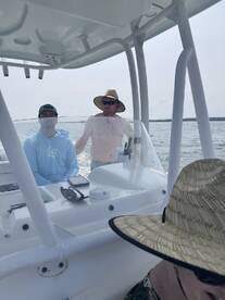 Two men enjoy a day on the water, showcasing the camaraderie and fun of boating adventures.