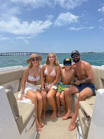A joyful family enjoys a sunny day on the boat, capturing the essence of summer fun and togetherness on the water.