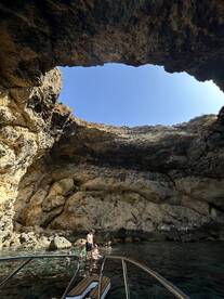 A family enjoys a refreshing swim in a stunning cave setting, surrounded by natural rock formations — a perfect spot for exploration and adventure.
