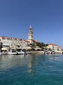 A picturesque view of a charming harbor with historic architecture and boats docked along the waterfront, perfect for exploring coastal destinations.