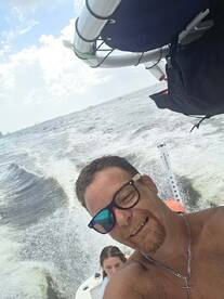 A joyful selfie captures two friends enjoying a day on the water, showcasing the fun and excitement of boating adventures.