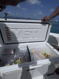 A YETI cooler filled with ice and drinks, perfect for keeping refreshments cold during a day on the water.