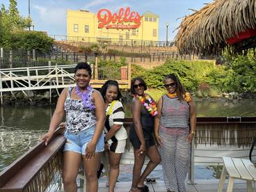 A group of friends poses for a fun photo on a boat, celebrating together at a waterfront location — perfect for memorable outings and gatherings.