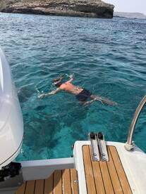 A snorkeler enjoys the vibrant underwater world in crystal-clear waters, showcasing the perfect adventure for marine exploration.